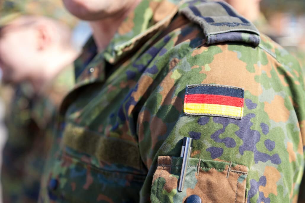 Bundeswehr-Soldat in Flecktarn-Uniform mit Deutschlandflagge – Soldaten und Strafbarkeit